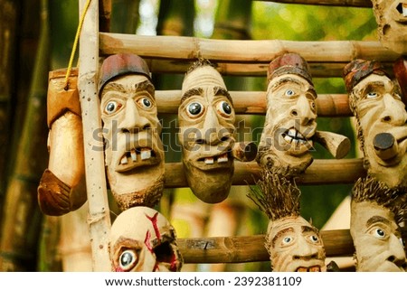 photo of a traditional mask made from bamboo and wood, often used as a toy for small children