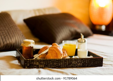 photo of tray with breakfast food on the bed inside a bedroom