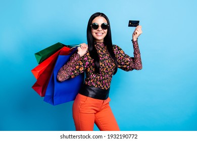 Photo of trendy brunette young woman hold plastic credit card bags sale isolated on blue color background
