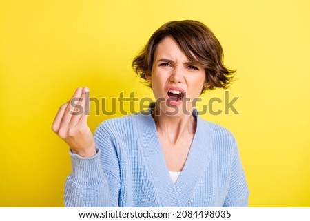 Photo of troubled offended lady raise fingers open mouth wear blue cardigan isolated yellow color background