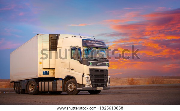 Photo of a truck, a car\
with a towed refrigerator against the sunset sky, 2019-10-13 Russia\
Rostov Region
