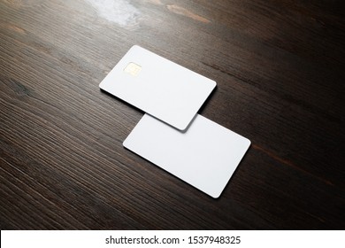 Photo Of Two Blank Credit Cards On Wood Table Background. White Bank Cards.