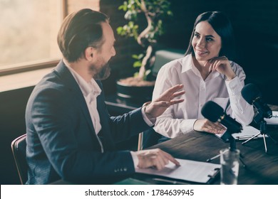 Photo of two business people corporate partners answer journalist press, conference questions speak mic political electoral campaign forum sit modern office indoors - Powered by Shutterstock