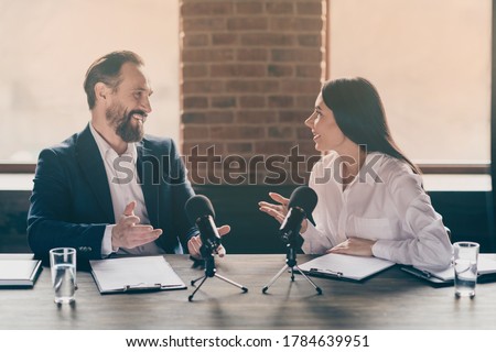 Photo of two business people corporate partners relationship answer, journalist press conference questions speak mic education political forum convention sit modern office indoors