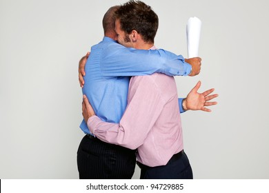 Photo Of Two Businessmen Hugging Each One Holding A Contract, Part Of A Series See My Portfolio For Them Fighting.