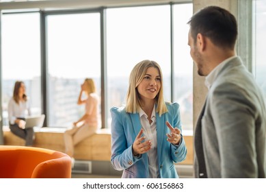 Photo of two colleagues discussing about the project in the office. - Shutterstock ID 606156863