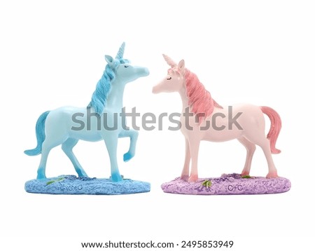 Photo of two colorful unicorn figurines titled 'Blue and Pink Unicorns,' showcasing a blue unicorn with one leg raised and a pink unicorn standing gracefully.
