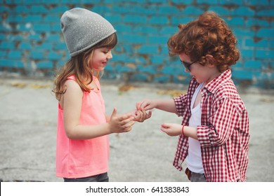 Photo Of Two Cute Hipsters Sharing Candy