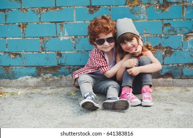photo of two cute hipsters sitting on floor