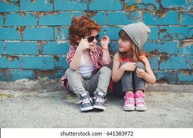 photo of two cute hipsters sitting on floor