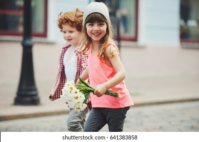 photo of two cute little hipsters running away
