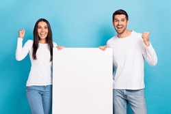 Photo Of Two Delighted Overjoyed People Raise Fists Empty Space Blank Isolated On Blue Color Background