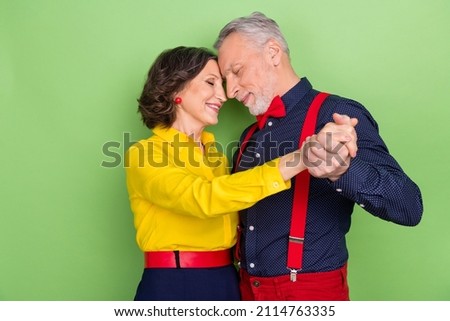 Photo of two dreamy idyllic people hold hands vintage discotheque isolated on green color background