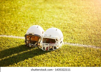 Photo Of Two Football Helmets On Stadium