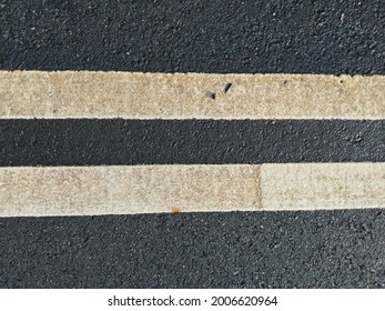 A Photo Of Two Lines Used As A Road Surface Marking, The Lines Were Made From Thermoplastic Resin, Mixed With Titanium Dioxide Pigment And Glass Beads