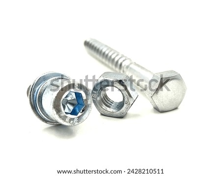 Photo of two metallic hexagonal bolts and a nut, isolated on white background.