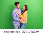 Photo of two peaceful cheerful partners hugging look each other toothy smile isolated on green color background