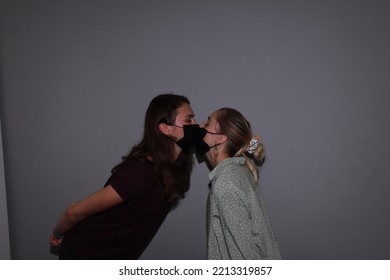 Photo Of Two People Kissing In Medical Masks