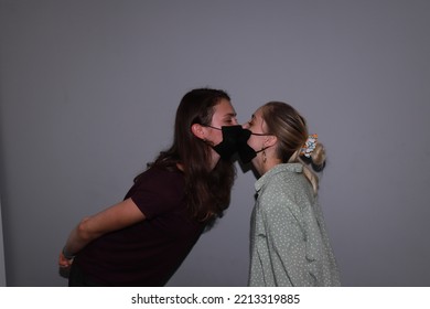 Photo Of Two People Kissing In Medical Masks