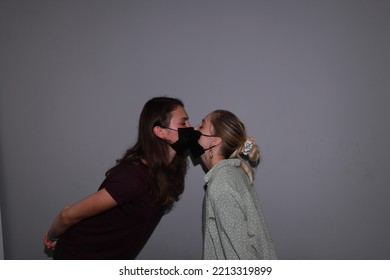 Photo Of Two People Kissing In Medical Masks