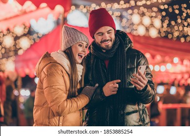 Photo of two people students friends browse social media on smartphone point finger x-mas christmas outdoors event - Powered by Shutterstock