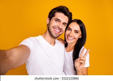 Photo Of Two People Taking Selfies Showing V-sign Saying Hi To All Followers Wear Casual Clothes Isolated Yellow Color Background