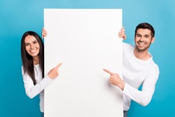 Photo Of Two Positive Nice People Indicate Finger Empty Space Proposition Isolated On Blue Color Background