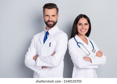 Photo of two positive professional doctors folded arms look camera isolated on grey color background - Powered by Shutterstock