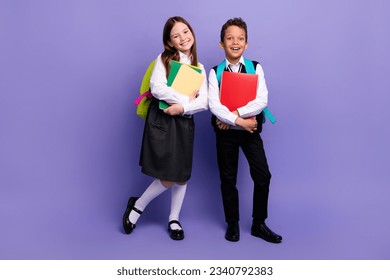 Photo of two school kids ready for first day buying supply for learning isolated bright color background