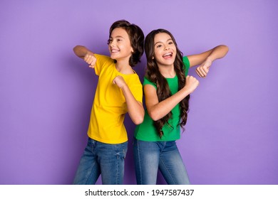 Photo of two trendy brunette cheerful children dance dream funky mood isolated on purple color background