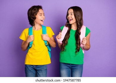 Photo Of Two Young Girl Boy Happy Positive Smile Humor Joke Laugh Hold Backpack School Study Isolated Over Purple Color Background