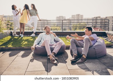 Photo of two young happy smiling joyful positive men sit armchair drink champagne talk speak communicate outside on rooftop - Powered by Shutterstock