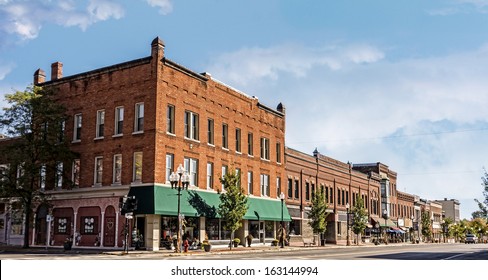 A Photo Of A Typical Small Town Main Street In The United States Of America. Features Old Brick Buildings With Specialty Shops And Restaurants. Decorated With Autumn Decor. 