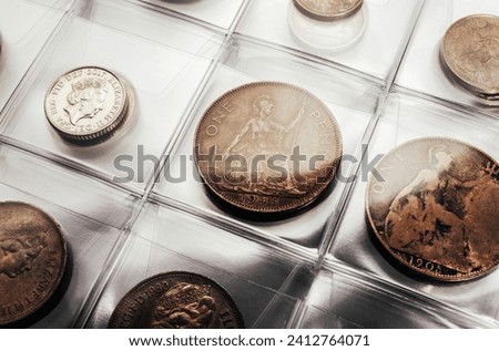 Photo of UK old british coins collection in a clear plastic sheet numismatic holder.
