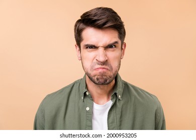 Photo Of Unhappy Aggressive Young Man Grimace Face Bad Mood Dislike Isolated On Pastel Beige Color Background