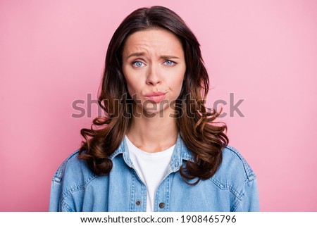 Photo of unhappy attractive young woman raise eyebrown dislike news isolated on pastel pink color background