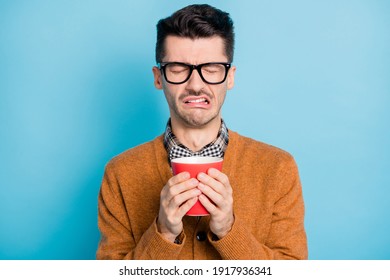 Photo Of Unhappy Sad Man Drink Bad Coffee Dislike Morning Wear Glasses Isolated On Pastel Blue Color Background