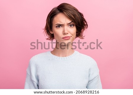 Photo of unhappy young woman bad mood irritated problem raise eyebrow isolated on pink color background