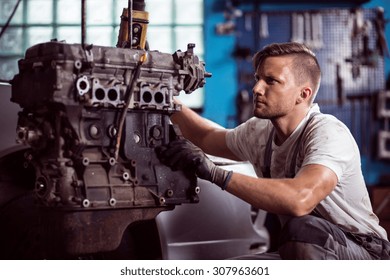 Photo Of Uniformed Car Technician Maintaining Automotive Engine