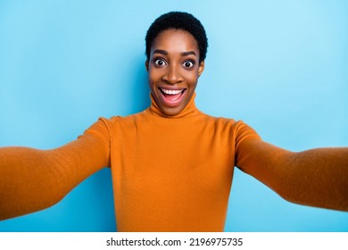 Photo Of Unisex Person Take Selfie Amazed Face Wow Reaction Open Mouth Wear Yellow Shirt Isolated Blue Color Background