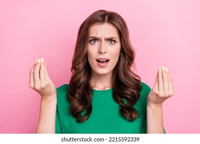 Photo of unsatisfied aggressive pretty woman show fingers ask why lost cash money bankrupt bad mood isolated on pink color background
