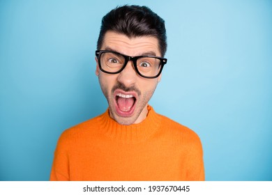 Photo of unsatisfied handsome guy open mouth scream yell loud wear sweater isolated on blue color background