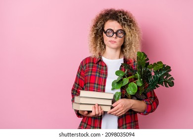 Photo Of Unsure Lady Hold Book Look Empty Space Dorm Relocation Concept Wear Specs Plaid Shirt Isolated Pink Color Background