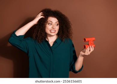 Photo of unsure uncertain woman wear green shirt lookiing binoculars empty space isolated brown color background - Powered by Shutterstock