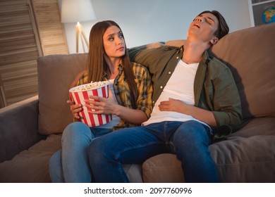 Photo Of Upset Tired Young Couple Wear Casual Shirts Sitting Couch Sleeping Watching Movie Eating Pop Corn Indoors House Room