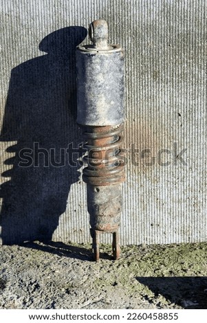 Photo of used motorcycle shock absorber on sunlight