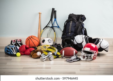 Photo Of Various Sport Equipments On Hardwood Floor - Shutterstock ID 597946445