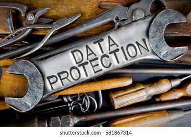 Photo of various tools and instruments with DATA PROTECTION letters imprinted on a clear wrench surface