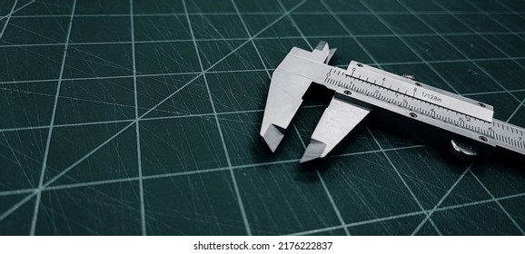 Photo of a vernier caliper with centimeters and millimeters. 
on a green background cutting mat - Powered by Shutterstock