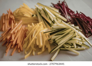 A photo of a vibrant array of julienned vegetables